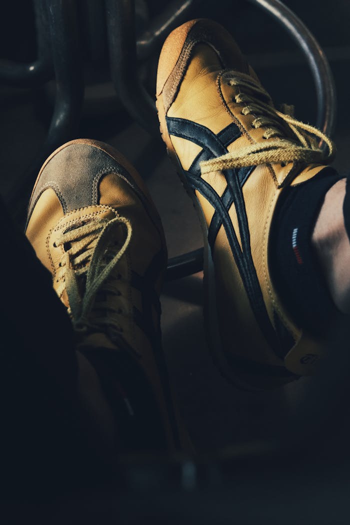 Mastering the First Impression: Your intriguing post title goes here Stylish vintage yellow sneakers with black stripes, showcasing classic footwear design.